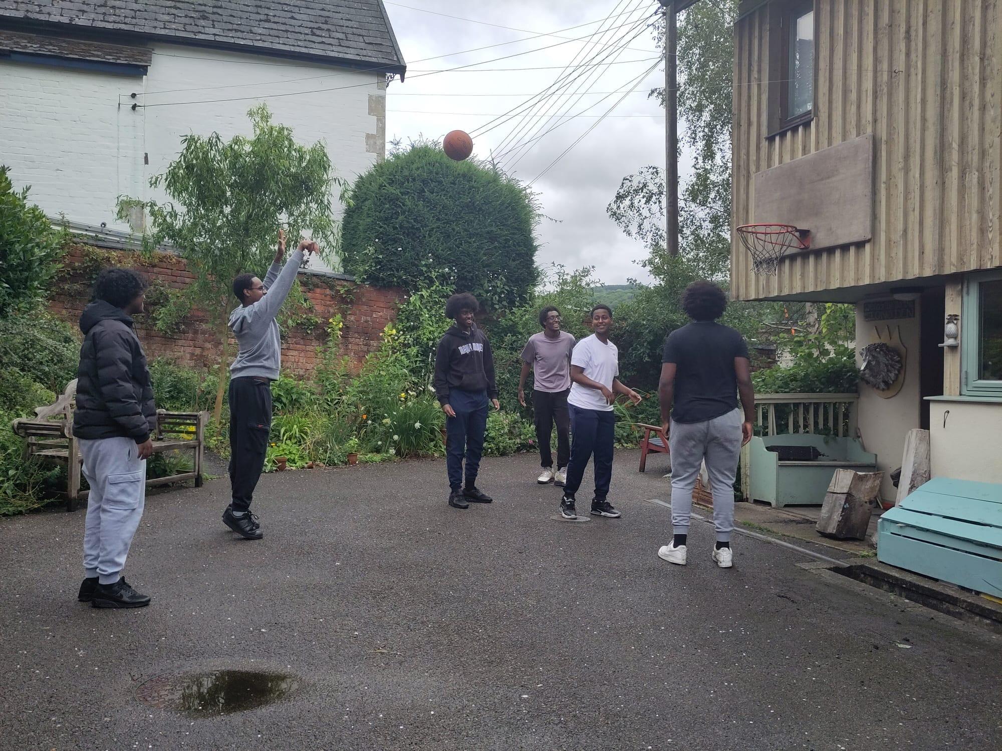 Community members playing basketball together, representing the vibrant community spirit at Somali Kitchen